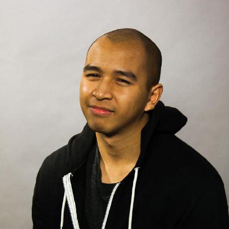 A man with a shaved head dressed in a black hoodie, looking directly at the camera.